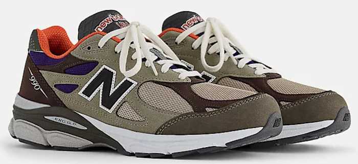 View of brown and orange New Balance shoes.